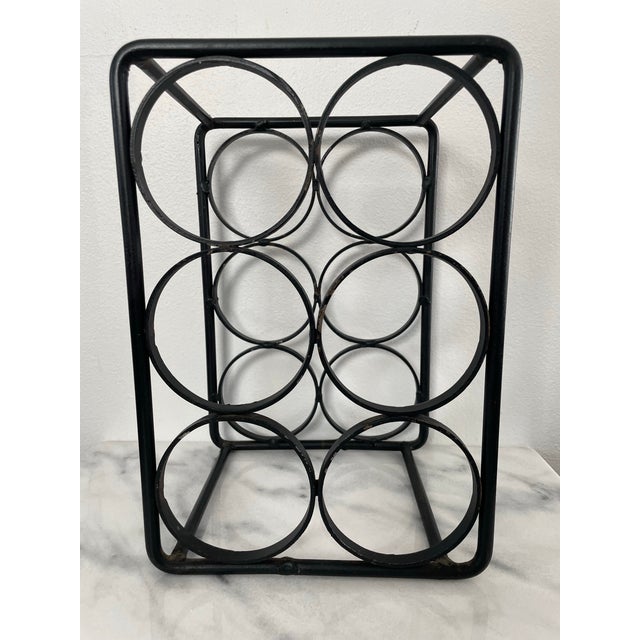 A minimal and stylish 6-bottle wine rack in the style of Arthur Umanoff. This wine rack features heavy wrought iron...