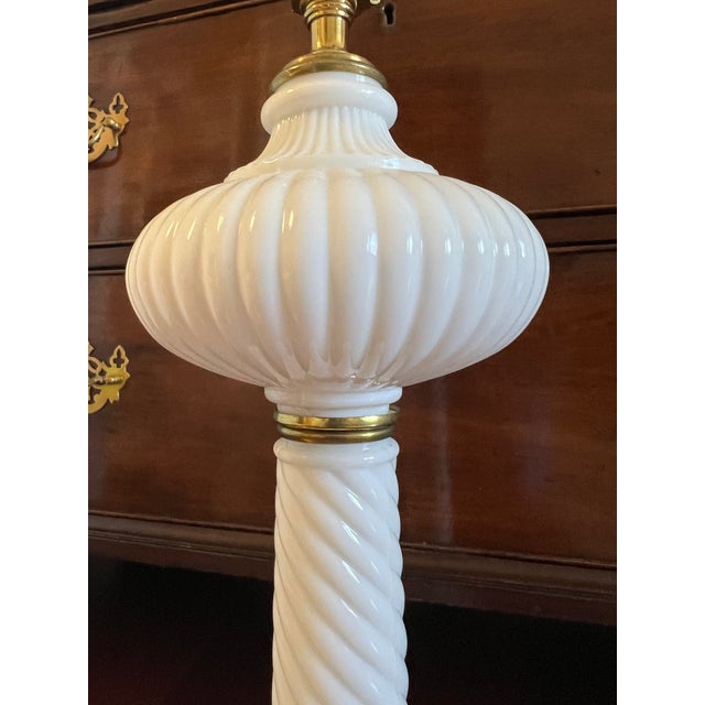 This particularly lovely vintage milk glass table lamp is adorned with swirls and fluting making it exceptionally elegant...