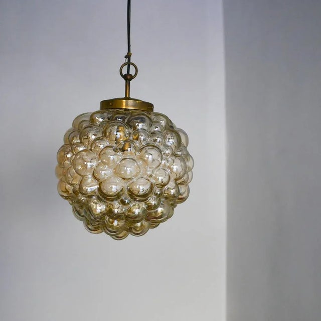 Copper-plated bubble glass chandelier from the 1960s. Made in Germany by Limburg. Designed by Helena Tynell. This piece...