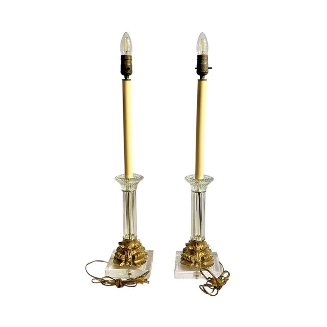An elegant pair of vintage Italian style table lamps featuring clear glass column bodies and lucite bases accented with...