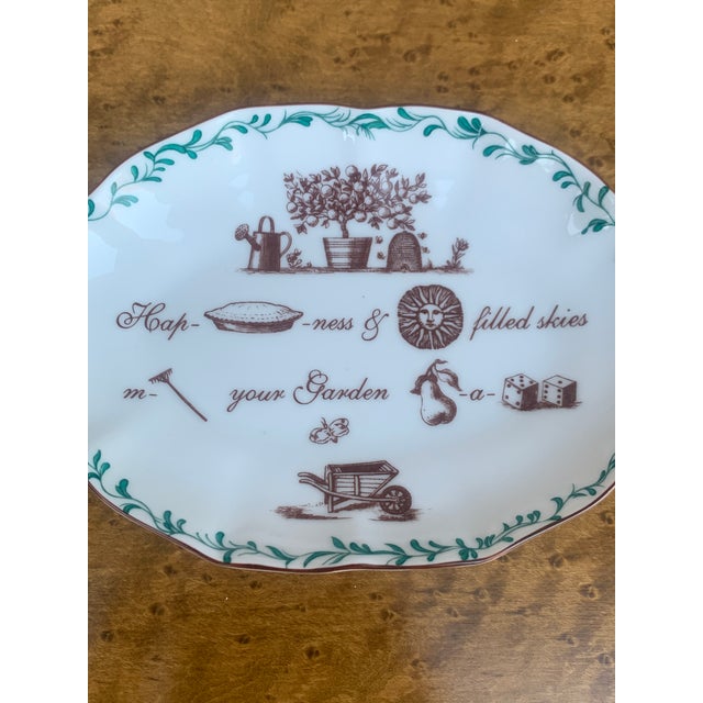 A gorgeous ceramic dish or catchall featuring a garden theme By Mottahedeh Portugal, Late 20th Century Measures: 5.75"W x...