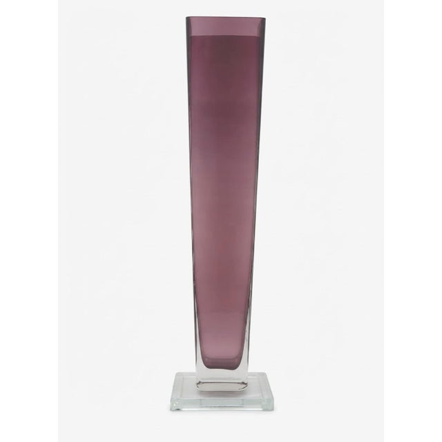 Striking tall Polish art glass vase with a sleek architectural silhouette and rich plum-purple coloration. The elongated...