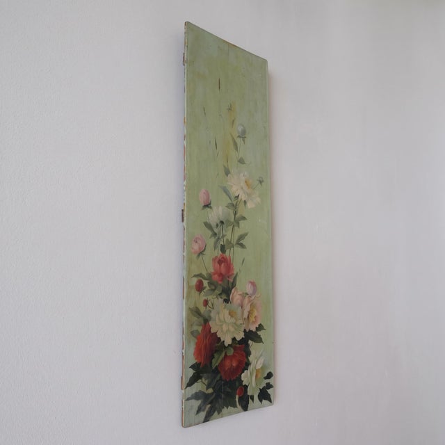 A tall, painted wooden panel, composed like a large cascade of peonies rising from the bottom to the top of the support....
