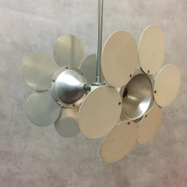 This vintage two-light daisy shaped aluminum swivel pendant was manufactured around the 1970s. European Plug (up to...