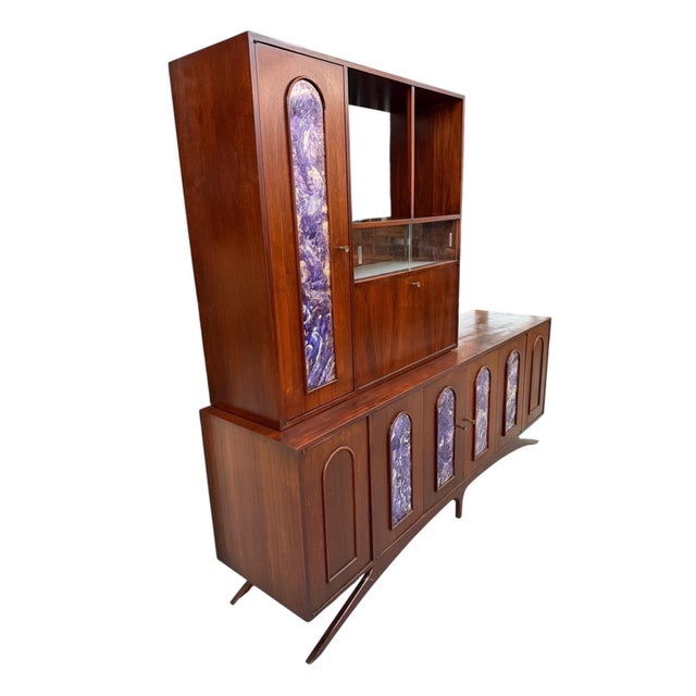 An exceptional and incredibly rare Mid-Century Modern two-piece walnut sideboard with bar cabinet, showcasing bold...