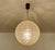 Very large mid century doria pendant light featuring a glass globe shade with a reliefed grid pattern, brass glass cap,...