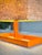 A highly sculptural vintage modern table lamp featuring a vivid architectural orange metal base paired with a rectangular...