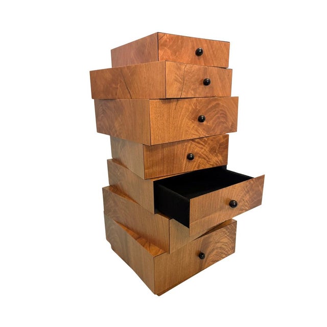 This very rare miniature drawer unit is made of walnut veneer. It is a small box-like structure with seven staggered...