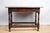 A rectangular oak side or occasional table, early 18th century, English. Features a single drawer with two brass pulls and...