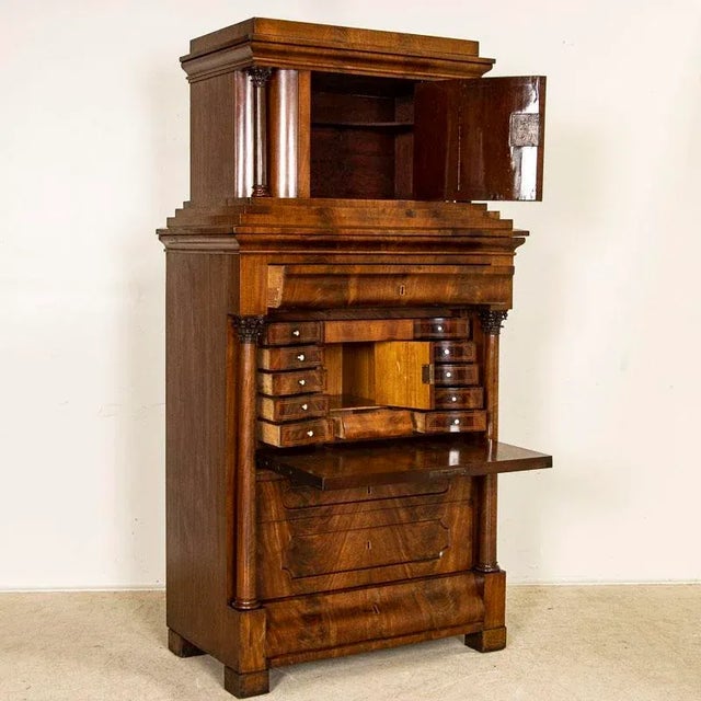 Rich dark wood and stately lines define this handsome Biedermeier drop front secretary from Germany. Note the concave...