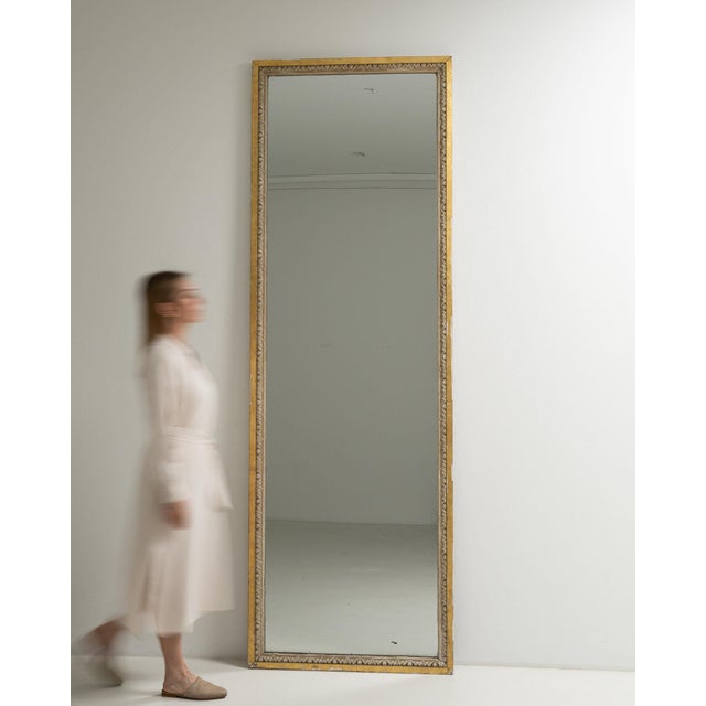 This piece presents as a mirror, distinguished by gold gilt slim frame, tall floor mirror. Originating in France during...