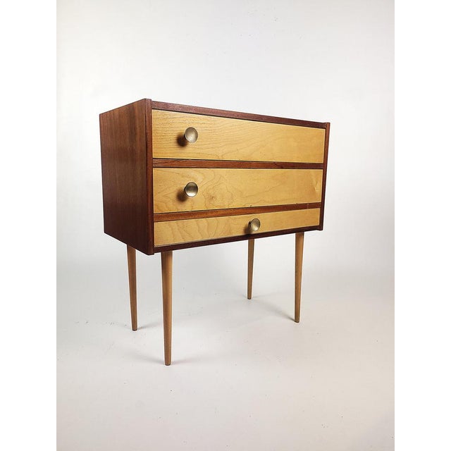 A stylish piece of furniture in the spirit of Mid-century Modern, combining the function of a sewing table with the...