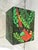 This vintage paper mache box is hand painted. It depicts a parrot and palm leaves. The interior is solid black