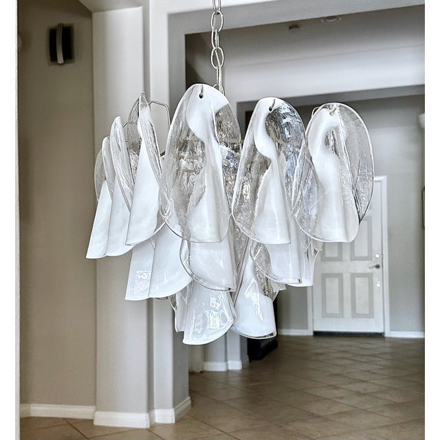 Mazzega handblown clear and white petal ceiling light chandelier. Glass petals suspended on newly wired four-light steel...