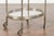 A vintage Italian oval steel trolley from the mid-20th century, with pierced gallery, mirrored shelves and casters....