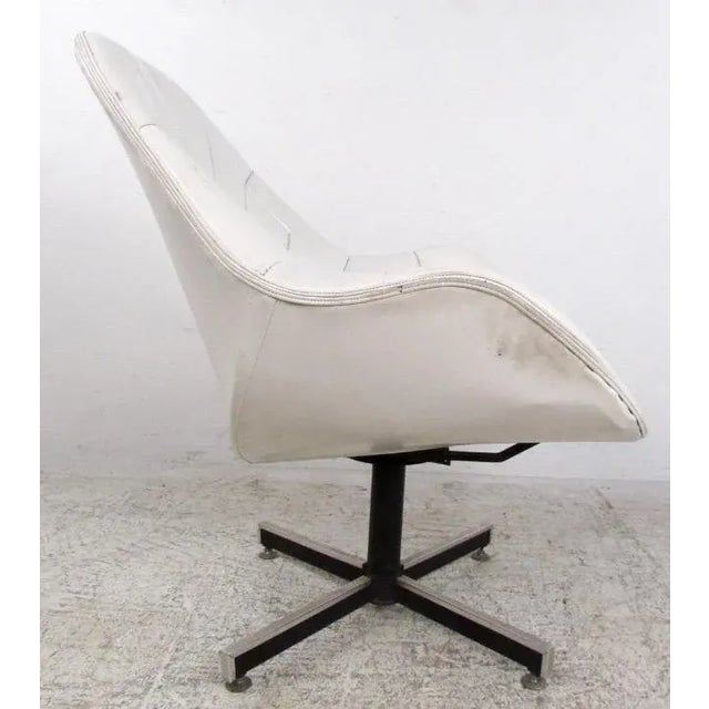 This Mid-Century swivel lounge chair features ornately stitched vinyl seat with a comfortable sculpted seat back. Unique...