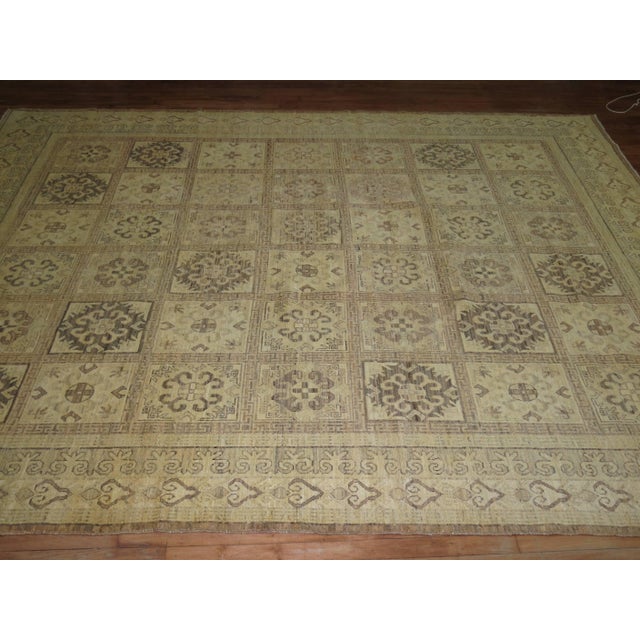 A vintage Khotan rug with an all-over panel design typically found in mid-20th century Persian Bakhtiar or Tabriz rugs....