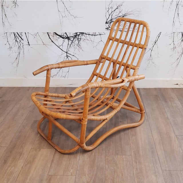 This set of 2 rattan lounge chairs distinguishes itself by the special design of the armrests. Both chairs are in good...
