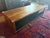 Black walnut coffee table with metal legs and single drawer. Ample under table storage on both sides. Top would benefit...