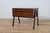 This Mid-Century rosewood console table was produced in Denmark in the 1960s.The console has profiled handles, giving it a...