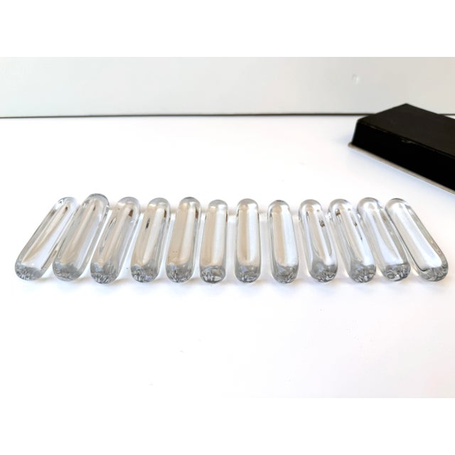 A refined set of twelve signed crystal knife rests by the celebrated French glassmaker Daum France. Crafted from heavy,...