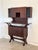 This 1960s-style mahogany bar cabinet consists of a sideboard and a wall cabinet with doors. The lower section can be set...