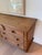 Substantial vintage pine dresser featuring a warm, naturally aged finish, seven paneled drawers, turned wood feet, and...
