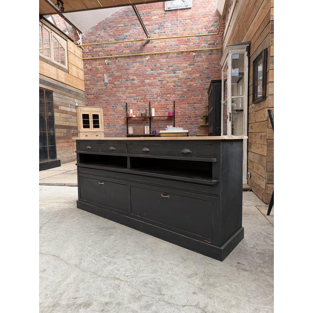 This antique workshop cabinet has been fully restored. It features a raw wood top and a black-patinated cabinet body. It...