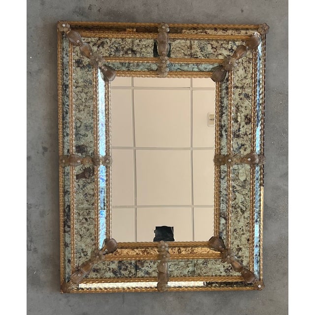 The square Venetian mirror has beveled panels and carved reliefs the mirror has been handmade and hand silvered. The...