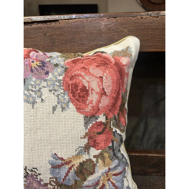 **Vintage, but never used** Charming vintage needlepoint pillow featuring a softly faded floral wreath composition in...