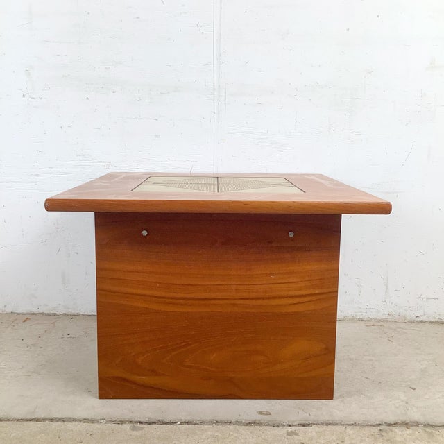 The combination of warm teak and hand-decorated ceramic tile is one of the signature material pairings of Danish mid-...