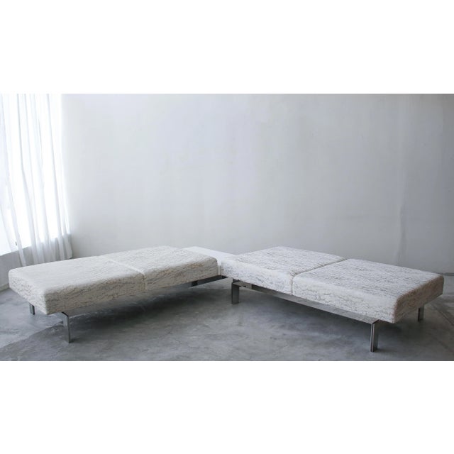 Gorgeous and substantial pair of mirrored stainless steel benches, with floating frames, one with an attached seamless,...