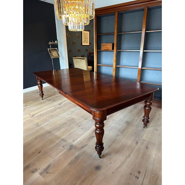 Large antique mahogany dining table suitable for 10 to 12 people with original extra leaves. Because it is a wind out...