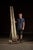Tall studio easel in wood with iron fittings and an adjustable sliding clamp for large-format canvases. Standing over...