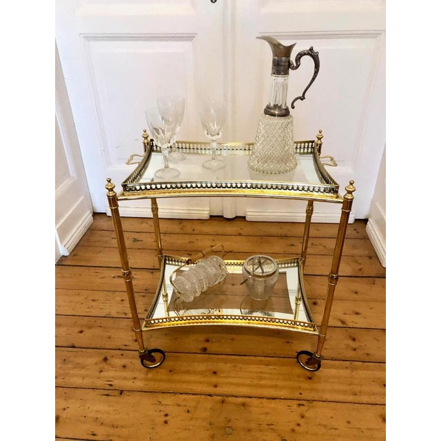 An elegant, fabulous mid-century brass coffee table or side table from the 1950s, featuring two crystal glass tops with...