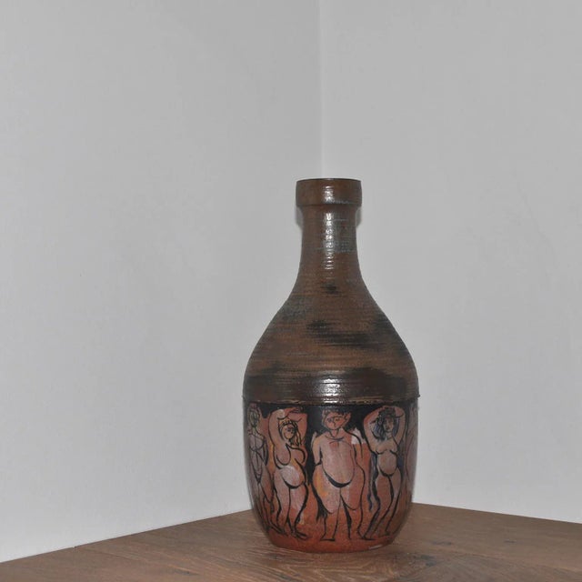 Remarkable studio ceramic vase with figure posed in various contrapposto poses. Marked "T10 60" on the underside.