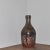 Remarkable studio ceramic vase with figure posed in various contrapposto poses. Marked "T10 60" on the underside.