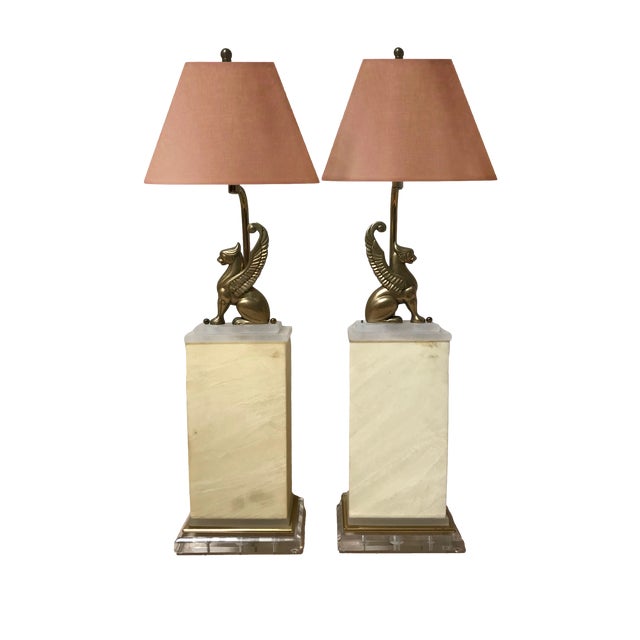 Pair of uber chic, vintage table lamps with gryphon motif. The mythical winged beasts that adorn these fixtures are mirror...