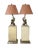 Pair of uber chic, vintage table lamps with gryphon motif. The mythical winged beasts that adorn these fixtures are mirror...