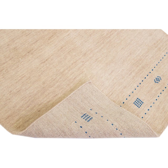 Beautiful modern Gabbeh Style hand-Loom wool rug with a beige field with gorgeous solid design. This rug measures: 4'2" x...