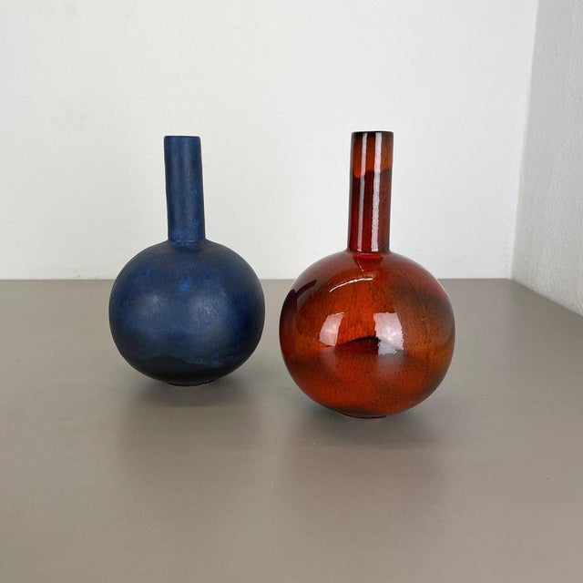 Article: set of 2 vases. Producer: Ruscha, Germany. Decade: 1960s : This original vintage vase set was designed and...