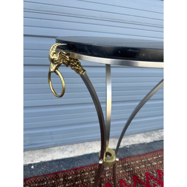 Maison Jansen French neoclassical steel and brass pedestal, in very good condition. Has detailings of rams head and rams...