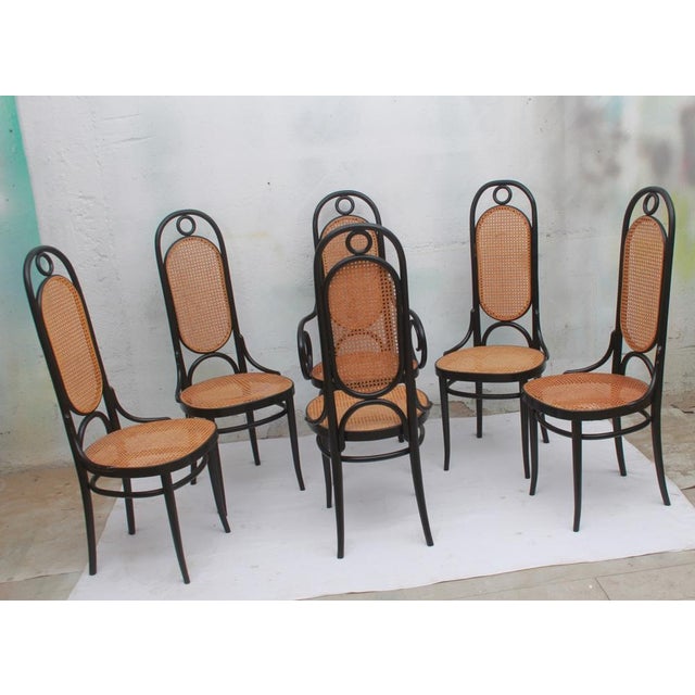 Set of six original Thonet chairs, model 207 R. Black finish with beige cane webbing. The webbing is undamaged; all chairs...