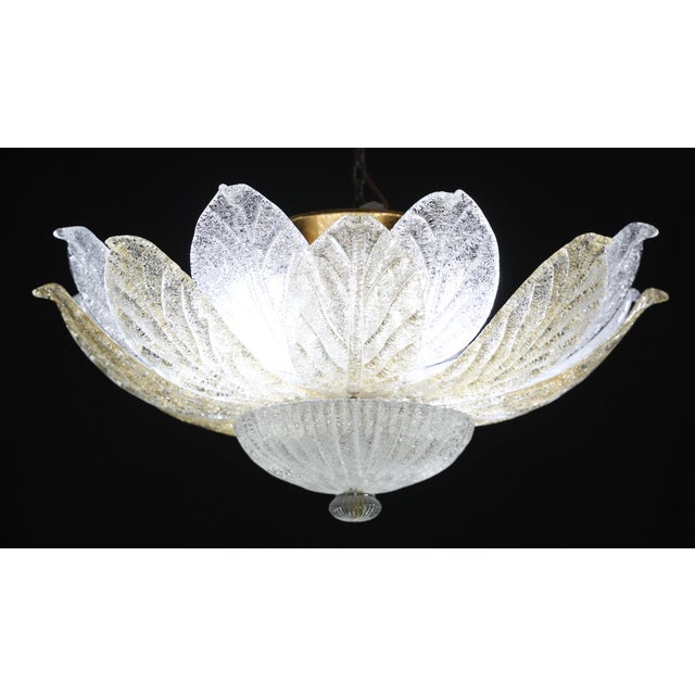 Splendid Murano glass ceiling lamp with alternating amber and transparent Murano glass leaves. Period: circa 1970. The...