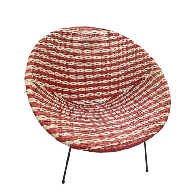 This striking mid-century armchair exemplifies the vibrant fusion of Indonesian craftsmanship and space-age design....