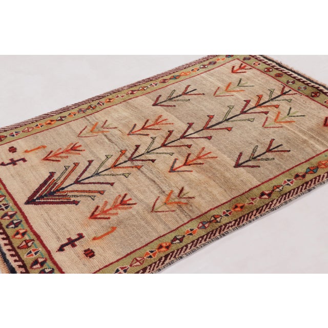 Hand-knotted in wool circa 1950–1960, this 4x6 vintage Persian Gabbeh rug is a refined entry in Rug & Kilim’s curation of...