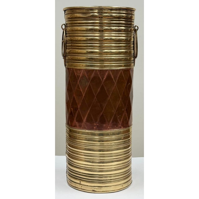 Unique vintage umbrella stand constructed of brass and copper. Features distinct brass horizontal ribbing at both top and...