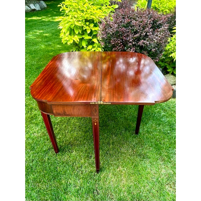 This antique, Federal-style, flame-mahogany game table, with a swivel and hinged, flip-top mechanism, is quite a...