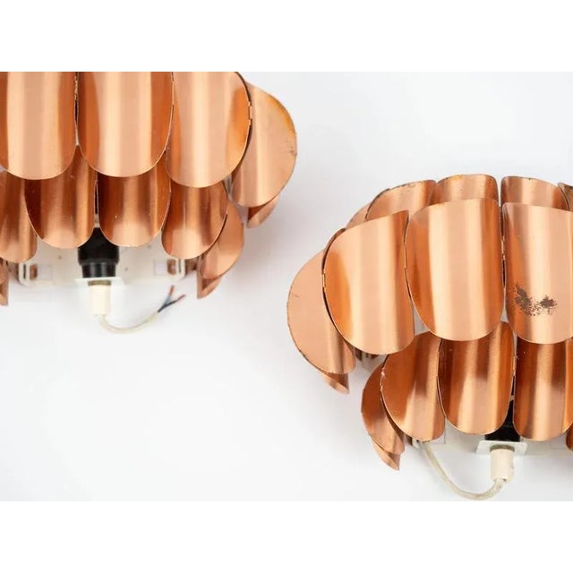 A pair of copper wall lamps from the 1960s. The lamps were designed by Thorsten Orrling for Hans-Agne Jakobsson....