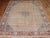 An early 20th century Room size Persian Tabriz worn rug with a small light blue central medallion on a herati design wheat...